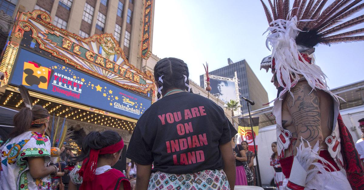 Native American protesters gather outside.