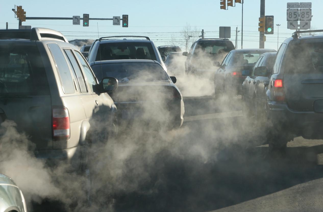 Exhaust gases emanating from various cars at a stop light.